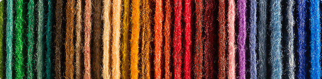Image of different coloured strands of yarn, as a rainbow.